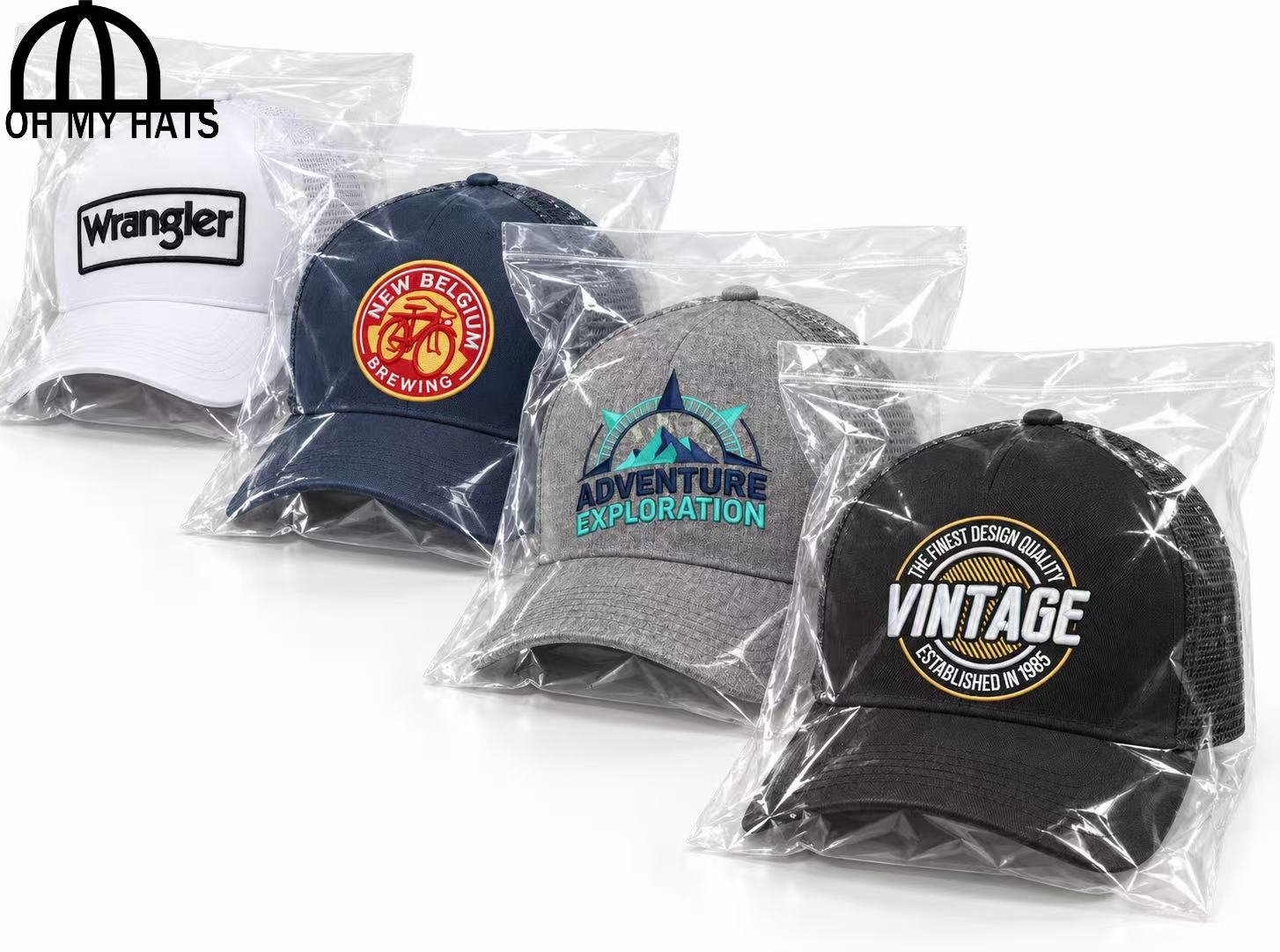 Four embroidered trucker hats individually wrapped in clear plastic bags, arranged diagonally on a white background.
