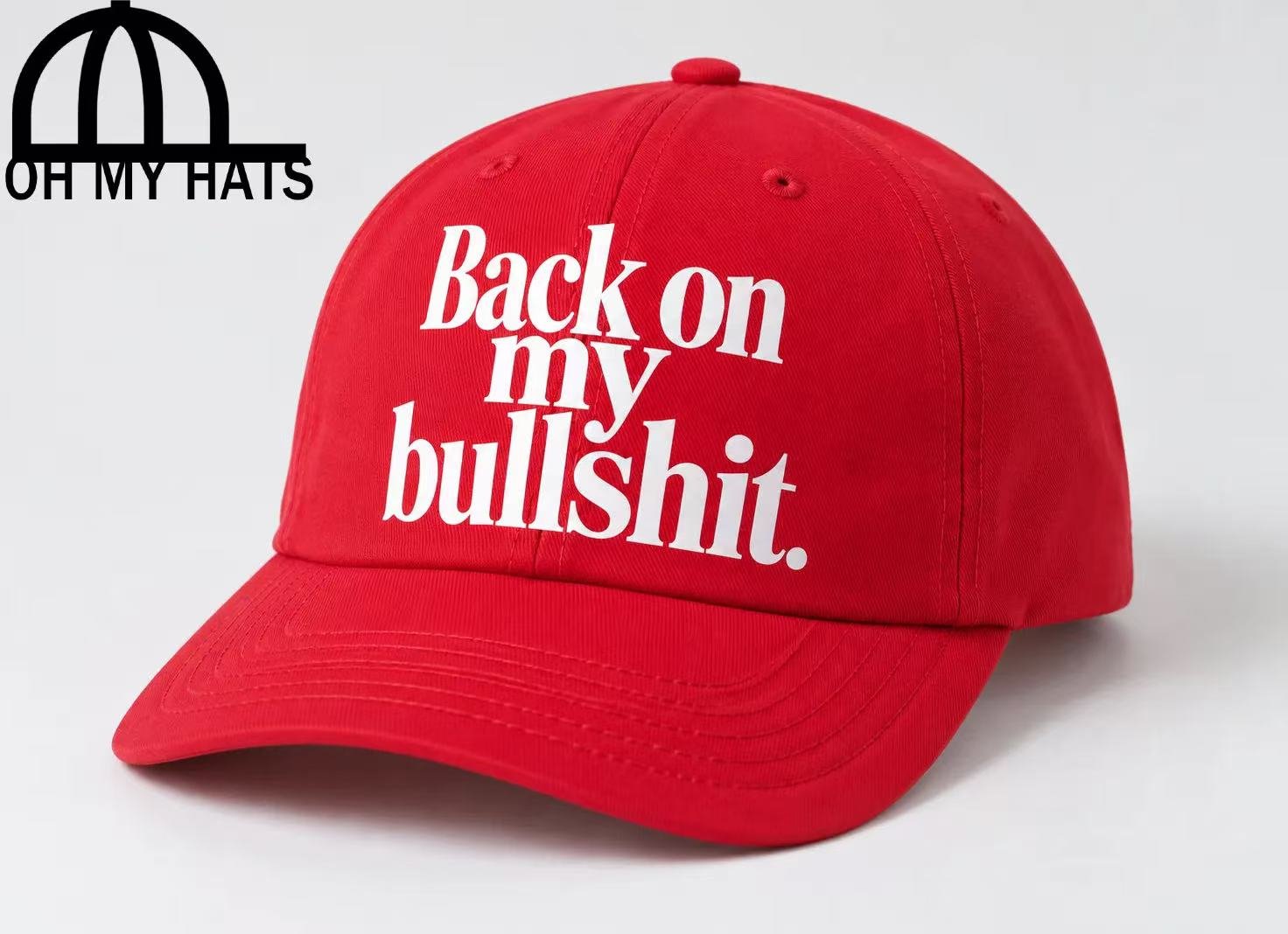 Red six-panel baseball hat with white slogan printing and a curved brim.