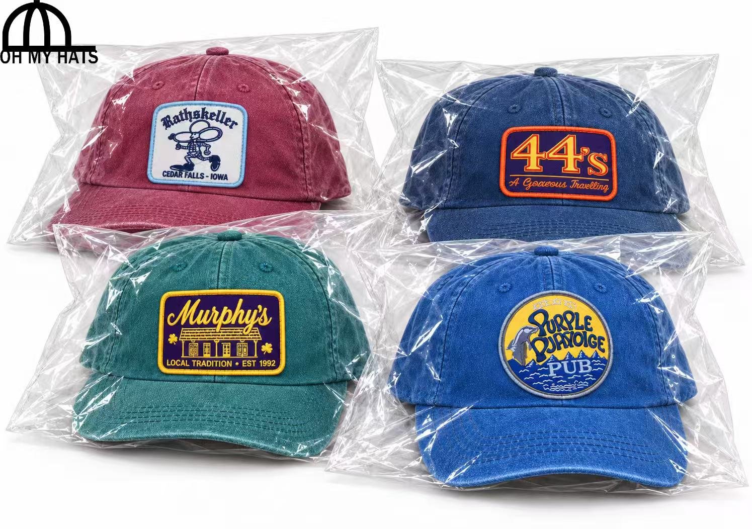 Four individually wrapped custom patch dad hats packed together in one large clear bag.