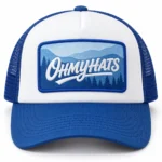 Blue and white foam trucker hat with an OHMYHATS mountain landscape patch, shown from the front on a white background.
