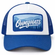 Blue and white foam trucker hat with an OHMYHATS mountain landscape patch, shown from the front on a white background.